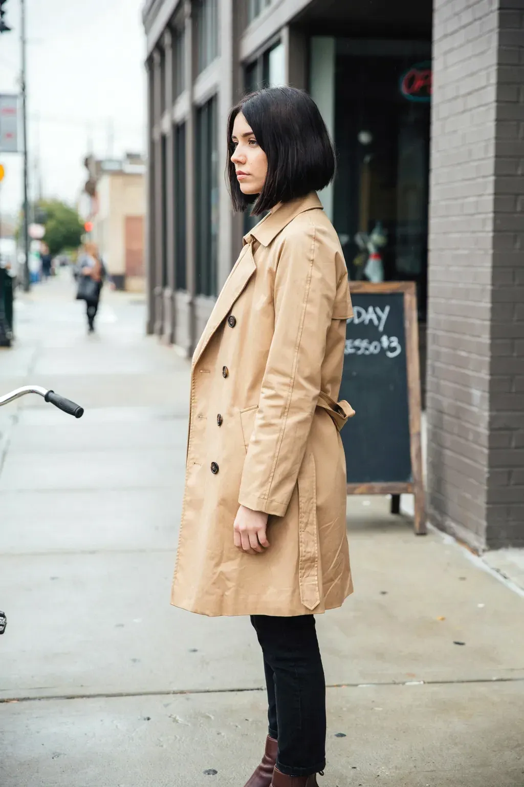 trench coat and asymmetrical bob