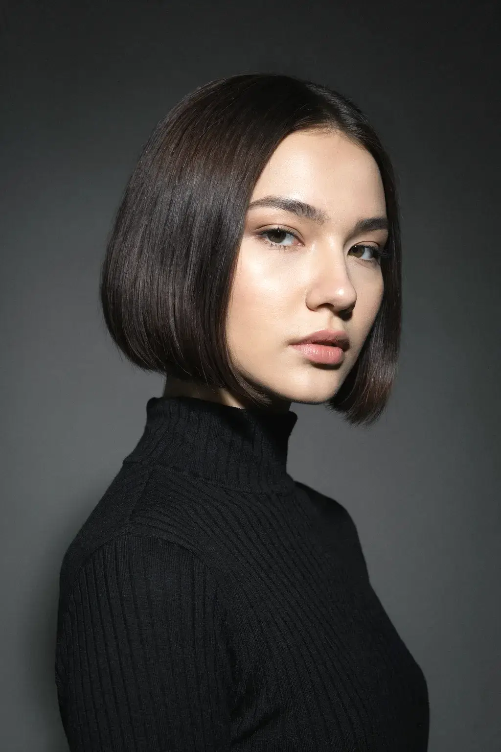 turtleneck sweater and blunt bob