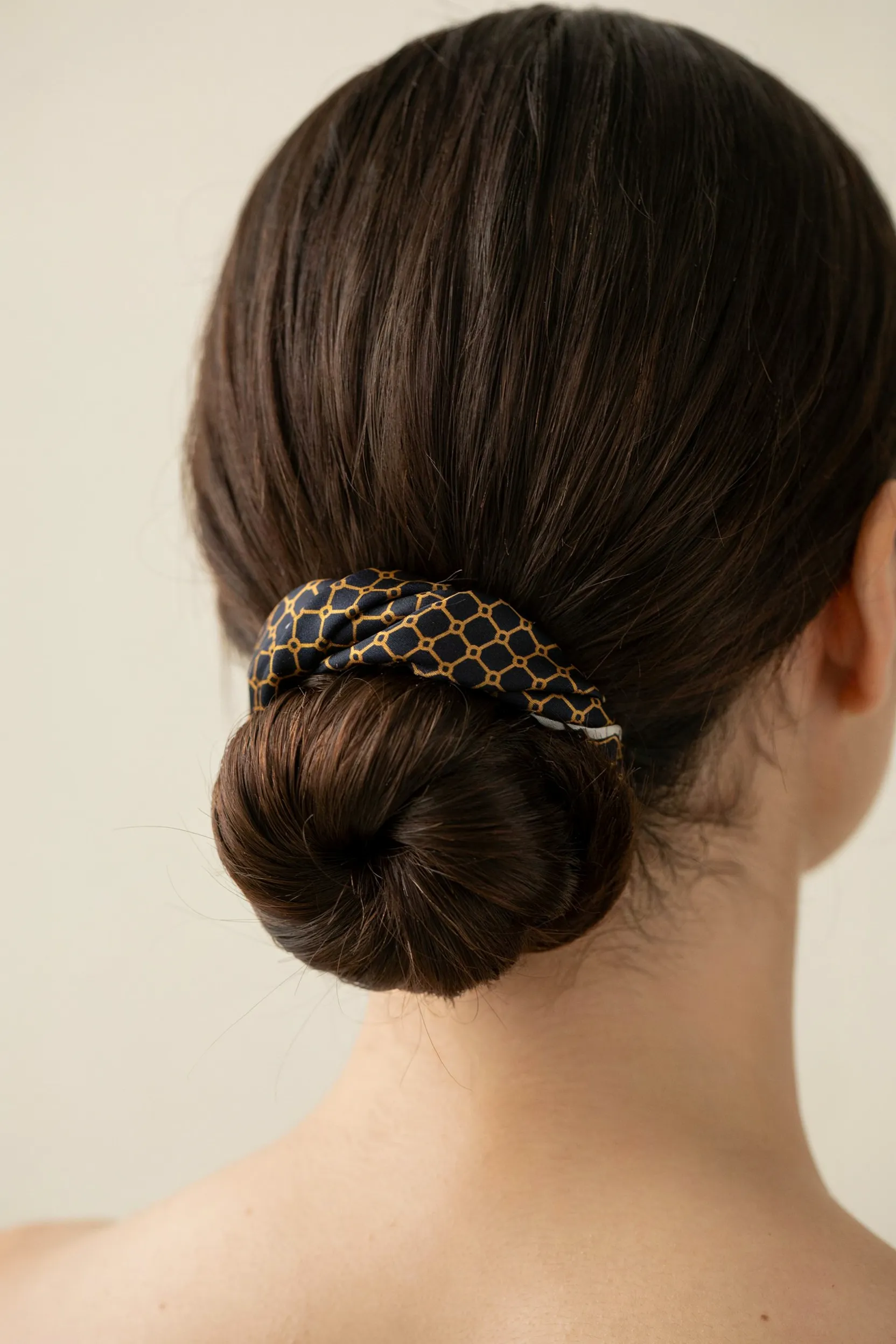scarf wrapped low bun